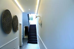 a staircase in a house with blue walls at 1 Craven Hill Gardens in London