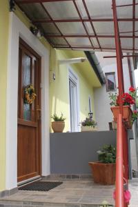 uma porta da frente de uma casa com vasos de plantas em La Bella em Sibiu