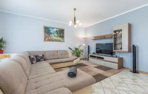 a living room with a couch and a flat screen tv at Villa Antonela in Radetići