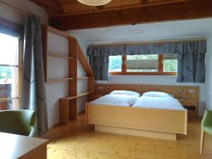 a bedroom with a bed and a book shelf at k&k Residenz in Bad Mitterndorf