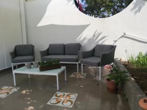 two chairs and a coffee table on a patio at Villetta Aurora in Lipari
