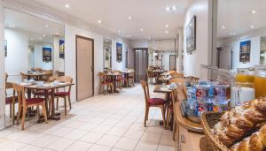 a restaurant with tables and chairs and a bakery at Hotel Ours Blanc - Place Victor Hugo in Toulouse