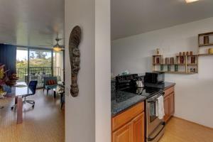 a kitchen with a stove and a dining room with a table at Mauna Loa Shores #405 condo in Hilo