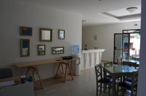 a dining room with a table and a table and chairs at Giorgos Apartments Square in Nea Vrasna
