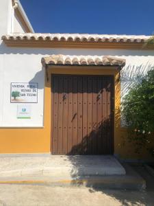 a door to a building with birds on it at Vivienda Rural Olivar de San Telmo in Arcos de la Frontera