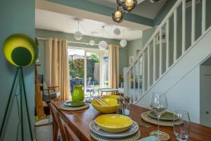 a dining room with a table with yellow dishes on it at On the Strand in Rye
