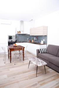 a living room with a couch and a table at La MaGiA di Villa in Villanova +10 photos