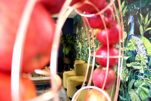 a room with a bunch of tomatoes hanging from a wall at 1 Craven Hill Gardens in London