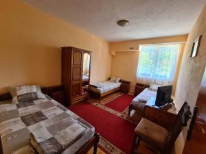 a room with two beds and a window at Villa Mura in Razlog