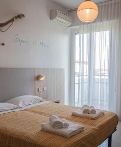 Postel nebo postele na pokoji v ubytování Hotel Astrid