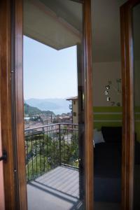 a door leading into a room with a balcony at La Casa di Emy in Solto Collina