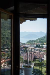 a window with a view of a city at La Casa di Emy in Solto Collina