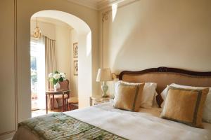 a bedroom with a large bed and an archway at Splendido, A Belmond Hotel, Portofino in Portofino