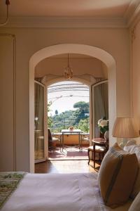 a bedroom with an archway leading to a dining room at Splendido, A Belmond Hotel, Portofino in Portofino