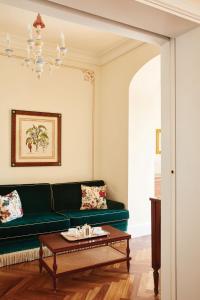 a living room with a green couch and a coffee table at Splendido, A Belmond Hotel, Portofino in Portofino