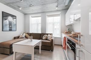 a living room with a couch and a table at Aalesund City Apartment in Ålesund