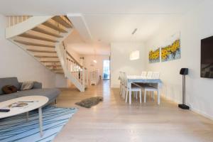 a living room with a couch and a table at 2Floors New Apartment & Charming Canal Surrounding in Copenhagen