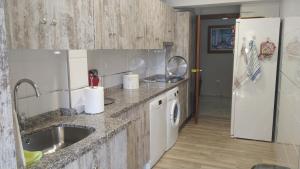 a kitchen with a sink and a white refrigerator at Apartamento Marín El Campello in El Campello