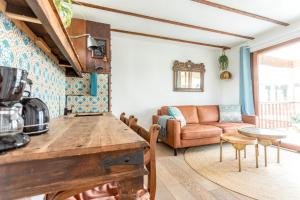 uma cozinha e sala de estar com um sofá e uma mesa em House boat studio with waterfront terrace em Amsterdã