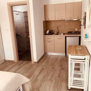 a kitchen with a table and a counter in a room at Alkyonari By Maria in Ammouliani