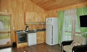 a kitchen with a refrigerator and a stove at Arcadia Villas in Cıralı