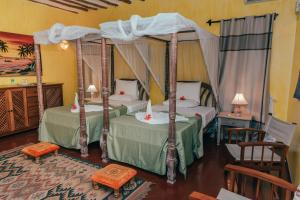 Giường trong phòng chung tại Hotel Villa Malindi