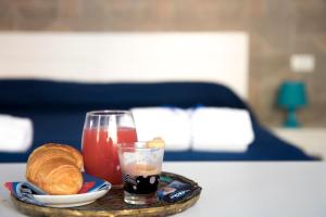 a tray with a drink and bread on a table at Megaride Santa Lucia in Naples