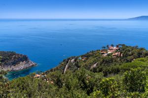 an island in the middle of a large body of water at Boutique Hotel Torre Di Cala Piccola in Porto Santo Stefano