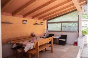 a dining room with a table and a bench at Apartments Miklus in Portorož +39 photos