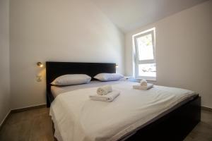 Postel nebo postele na pokoji v ubytování Apartments ZINA