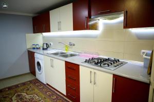 a kitchen with a sink and a stove top oven at Guest House in Gyumri in Gyumri
