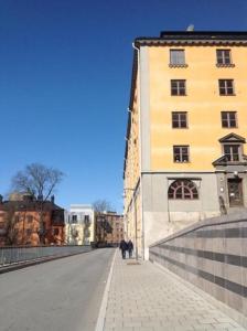 a person walking down a sidewalk next to a building at Crafoord Place Hostel in Stockholm