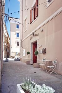 a street with two chairs in front of a building at Vila Piranesi Apartments in Piran +28 photos