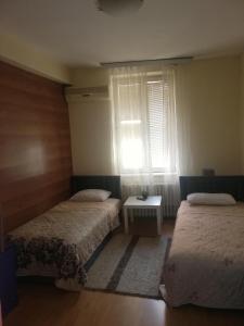 a hotel room with two beds and a window at B & B 903ta in Skopje