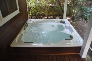 a jacuzzi tub in the backyard of a house at Arcadia Villas in Cıralı