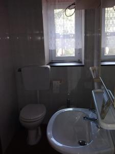 a bathroom with a sink and a toilet and a window at Appartamento Il Girasole in Montale