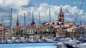a bunch of boats are docked in a harbor at Marco's House in Alghero