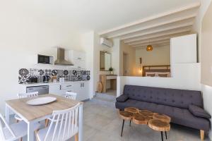 a living room with a couch and a table at CIEL BOUTIQUE VILLAS in Afiartis