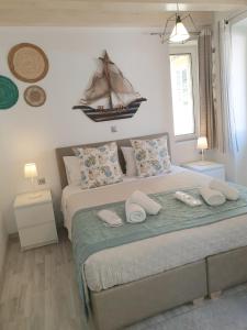 a bedroom with a bed with a boat on the wall at Helens Apartment in Corfu