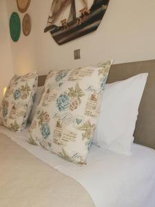 a bed with two pillows on top of it at Helens Apartment in Corfu Town