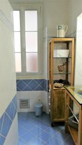 Villesèque-des-CorbièresにあるLa Maison Des Vendangeursの青いタイルフロアのバスルーム(窓付)