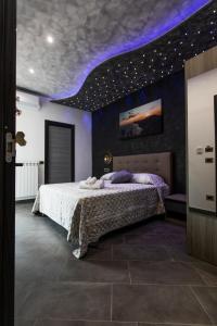 a bedroom with a bed with a purple ceiling at Golden Eagle in Agerola
