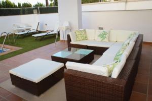 a patio with two couches and a table and chairs at VILLA TAZA DE PLATA A in Huétor Vega