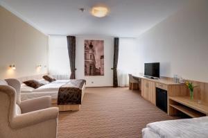 a hotel room with two beds and a television at Hotel GTC 3* superior in Bílovec