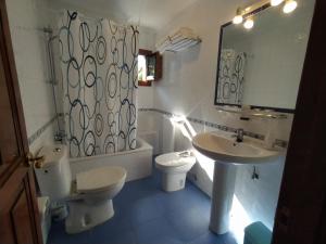 a bathroom with a sink and a toilet and a mirror at Villalen in Cuerres