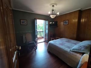 a bedroom with a bed and a sliding glass door at Villalen in Cuerres