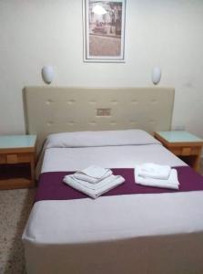Voodi või voodid majutusasutuse Minaides Hotel toas
