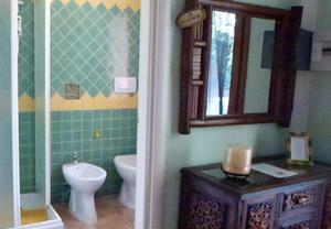 a bathroom with a toilet and a sink and a mirror at B&B Meladormo in Tempio Pausania +34 photos