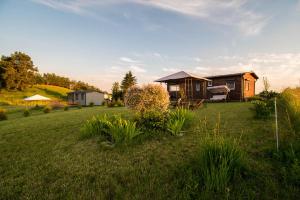 a house in a field with a yard at Kingsajz in Giżycko
