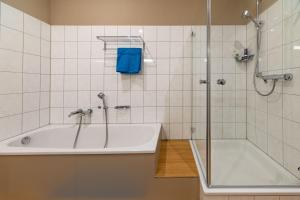 a bathroom with a tub and a shower and a tub at Edelburg 3 - Ferienwohnung in Hemer